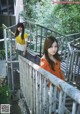 Two young women standing on a set of stairs.