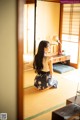 A woman sitting on the floor in front of a mirror.