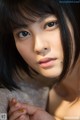 A close up of a woman with long black hair.